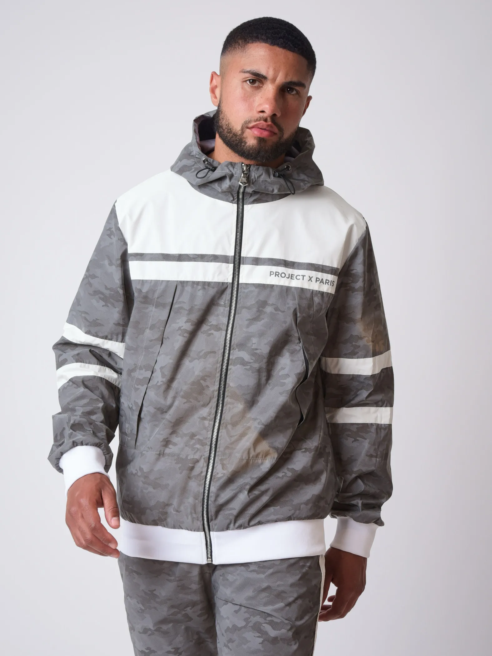 Chaqueta bimaterial reflectante con capucha y estampado de camuflaje 