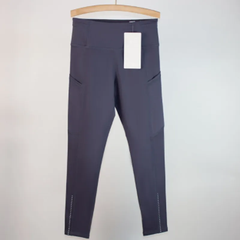 Los pantalones de yoga deportivos femeninos alinean leggings de bolsillo múltiples cepillados de doble cara para la conducción f