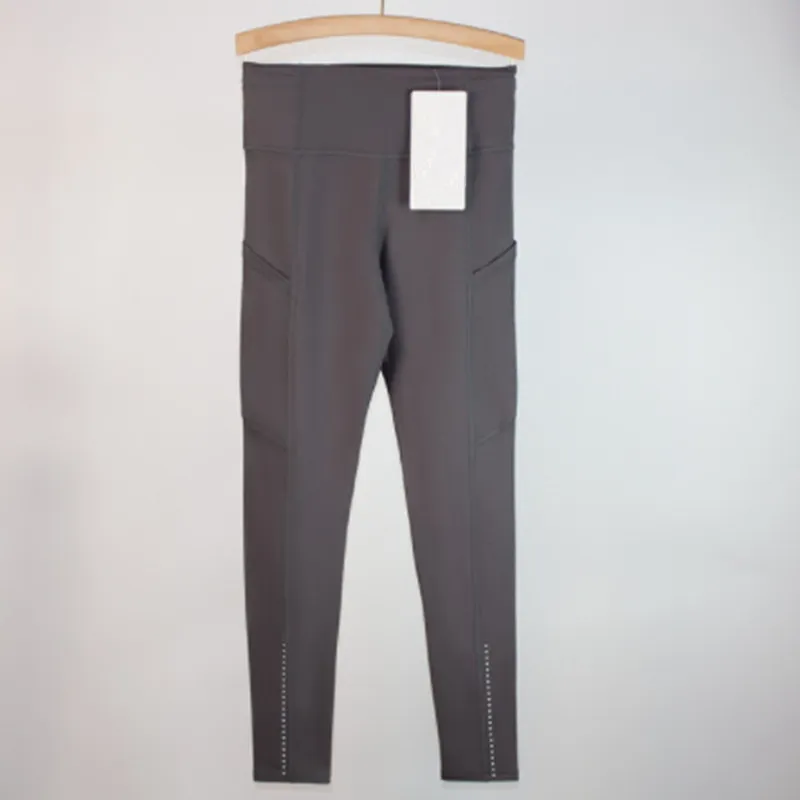 Los pantalones de yoga deportivos femeninos alinean leggings de bolsillo múltiples cepillados de doble cara para la conducción f