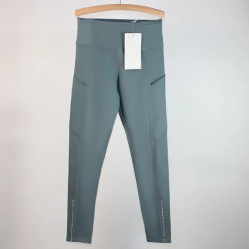Los pantalones de yoga deportivos femeninos alinean leggings de bolsillo múltiples cepillados de doble cara para la conducción f
