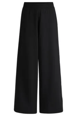 Pantalones de chándal de pernera ancha en algodón elástico con cinta de logos