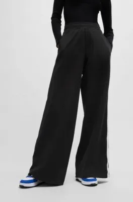 Pantalones de chándal de pernera ancha en algodón elástico con cinta de logos