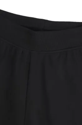 Pantalones de chándal de pernera ancha en algodón elástico con cinta de logos