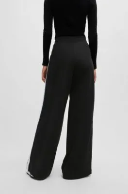 Pantalones de chándal de pernera ancha en algodón elástico con cinta de logos