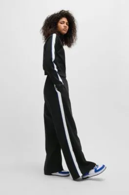 Pantalones de chándal de pernera ancha en algodón elástico con cinta de logos